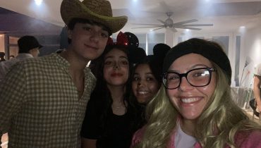 Fellows and teens celebrating Purim with a costume party